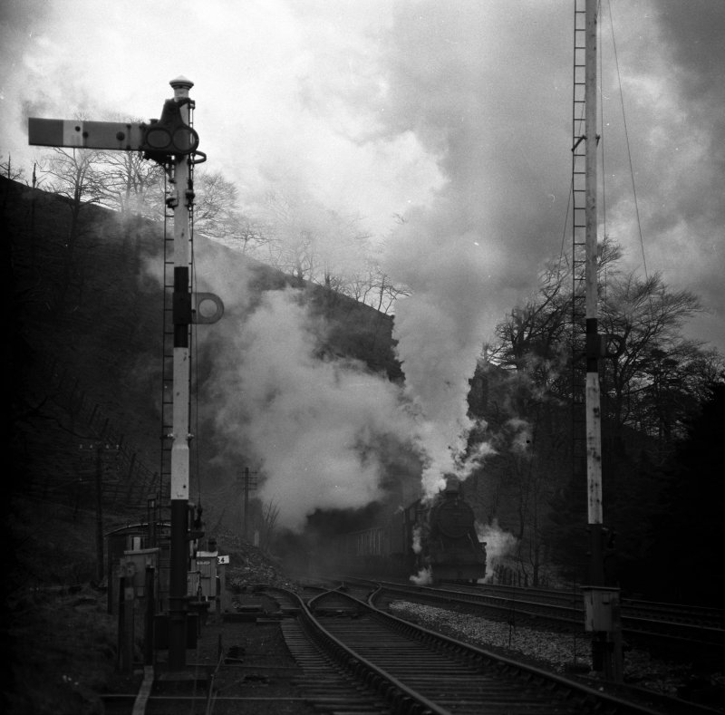 Stanier 8F 48466 bursts out of Holme Tunnel and arrives at Copy Pit with a Yorkshire bound haul of empty coal wagons.