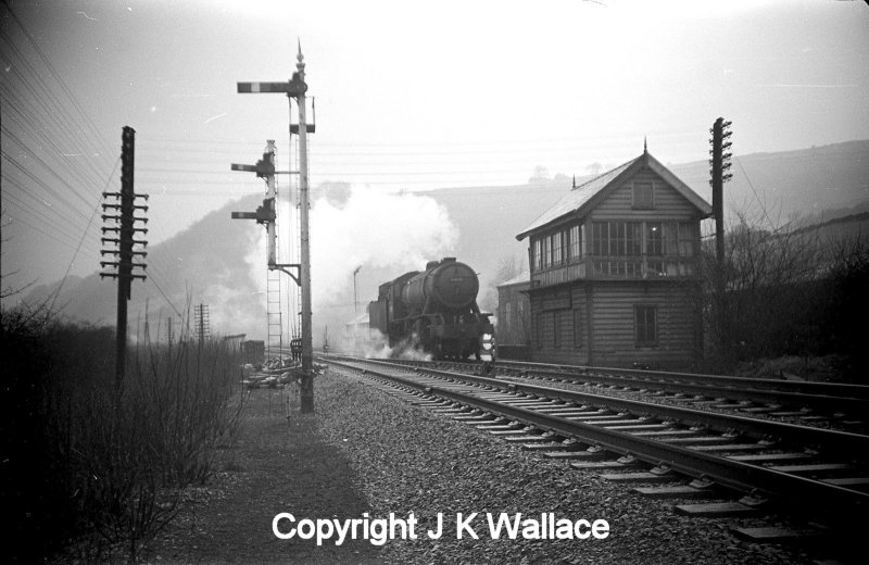 A WD Austerity 2-8-0 drifts past Dover Bridge signal box in the Calder Valley light engine in the early 60s