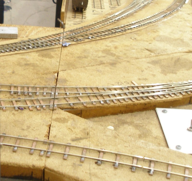 Shipley Model Railway Society's Leicester South layout baseboad joint showing use of PCB to secure the rails at the joint.