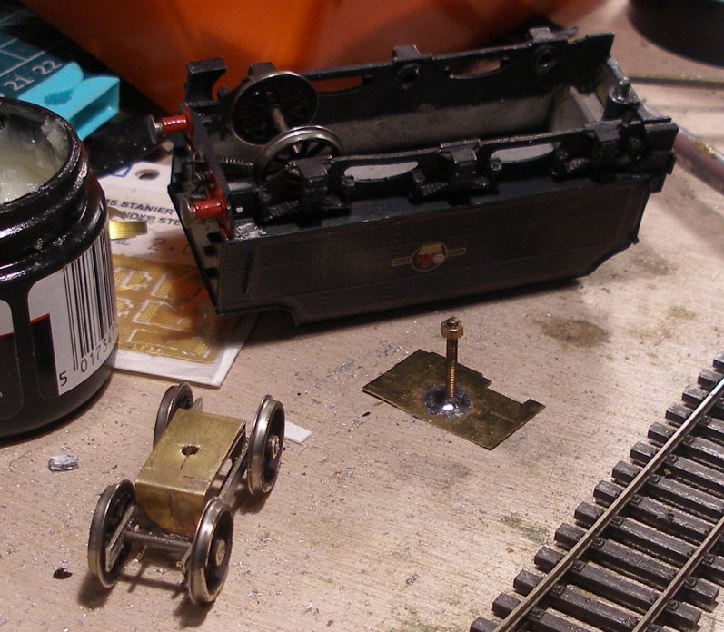 A hole was drilled in the top of the free bogie for the bolt. A strechter is shown with the bolt soldered to it, ready for fixing inside the tender on the ledges formed by the frames with superglue.