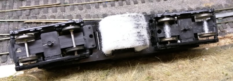 Triang track cleaner showing the cleaning effect and also the fibres that have been shed and have wrapped themselves around the trailing axles.