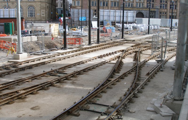 Manchester Victoria Railway Station 11 April 2015 on the occasion of a guided tour organised by the Lancashire & Yorkshire Railway Society: tram entrance from the city centre, showing new tracks for the second crossing to the right. Note the diamond crossing in the centre of the layout, and the way if it formed with both tracks on a curve.