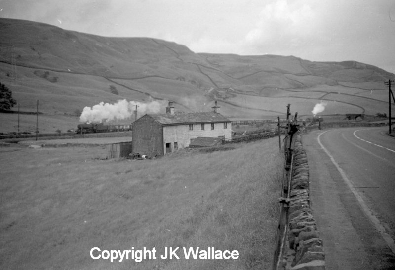 WD Austerity 90412 and banker Crab 42727 ares seen passing Ratten Clough Cottage on the climb to Copy Pit and Rose Grove in the early 1960s.