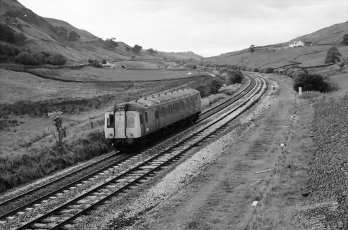 Class 121 or 122 heads away from Todmorden at Copy Pit, passing the site of the old loop, on a route learning trip on 24/9/1984
