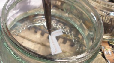 DJH Crab: The Fox lining transfer is securely held with a pair of pliers and dipped in a bowl of water.