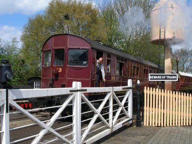 The wonderfull level crossing cameo created at Didcot Railway Centre with Rail Motor 93 running through. Driver bending out of cab to give up the signel line train staff to the signal man.
