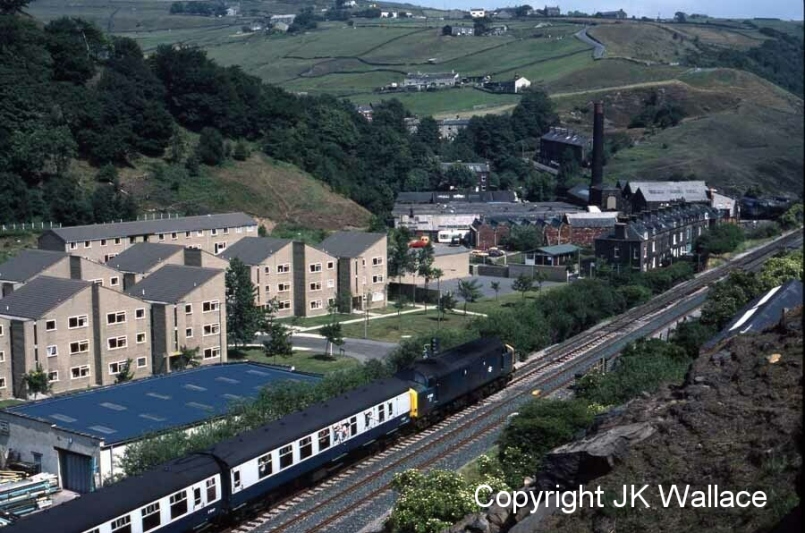 Class 37 37209 is snapped at Cornholme with an excursion from Sheffield bound for Blackpool on 20 August 1984.