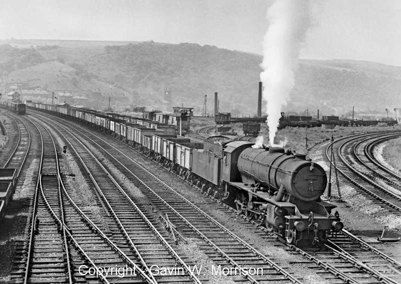 Gavin Morrison has kindly allowed reproduction of his photo showing Riddles 'WD' class 2-8-0 No. 90523 with a eastbound coal freight heading for Healey Mills on the Lancashire & Yorkshire down loop on 14 June 1961. 