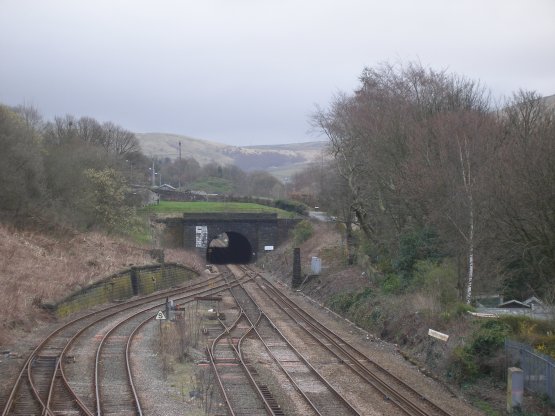 Hall Royd Junction looking eastwards on 19 April 2013 showing recent clearance work undertaken by Network Rail. The pillars of the Lower Laithe House footbidge are now apparent: there is one incorporated in the boundary wall; one next the track and one incorporated in the retaining wall. There is a further pillar up the hillside not apparent in the photo. 