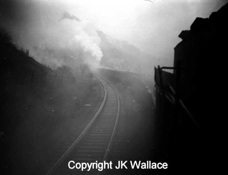 An up mineral bound seen from the footplate of the lead WD Austerity 2-8-0 bound for Copy Pit erupts from Kitson Tunnel with the banker fully engaged.