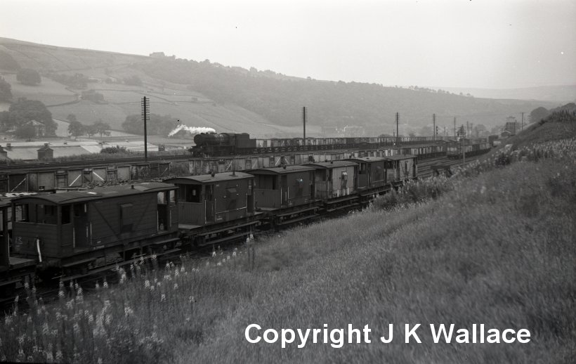An unknown WD 2-8-0 passes Mytholmroyd sorting sidings with a westbound mineral (coal) train in 1963.