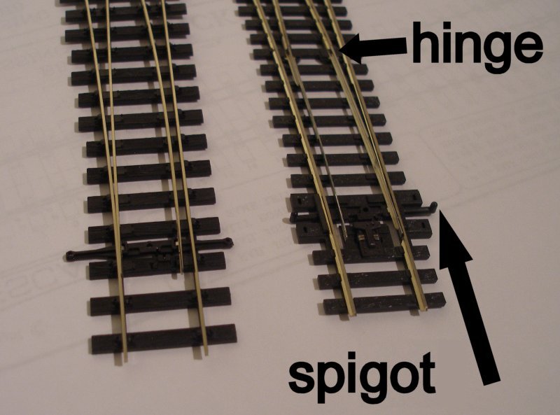 PECO Streamline Bullhead OO scale Code 75 Unifrog point (turnout)  alongside a PECO HO point showing the original hinge and revised tie-bar.