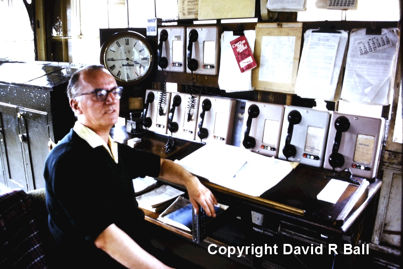 Sowerby Bridge signal box interior 1971 with the signal man next to the phones. Taken at 3. 45 pm.