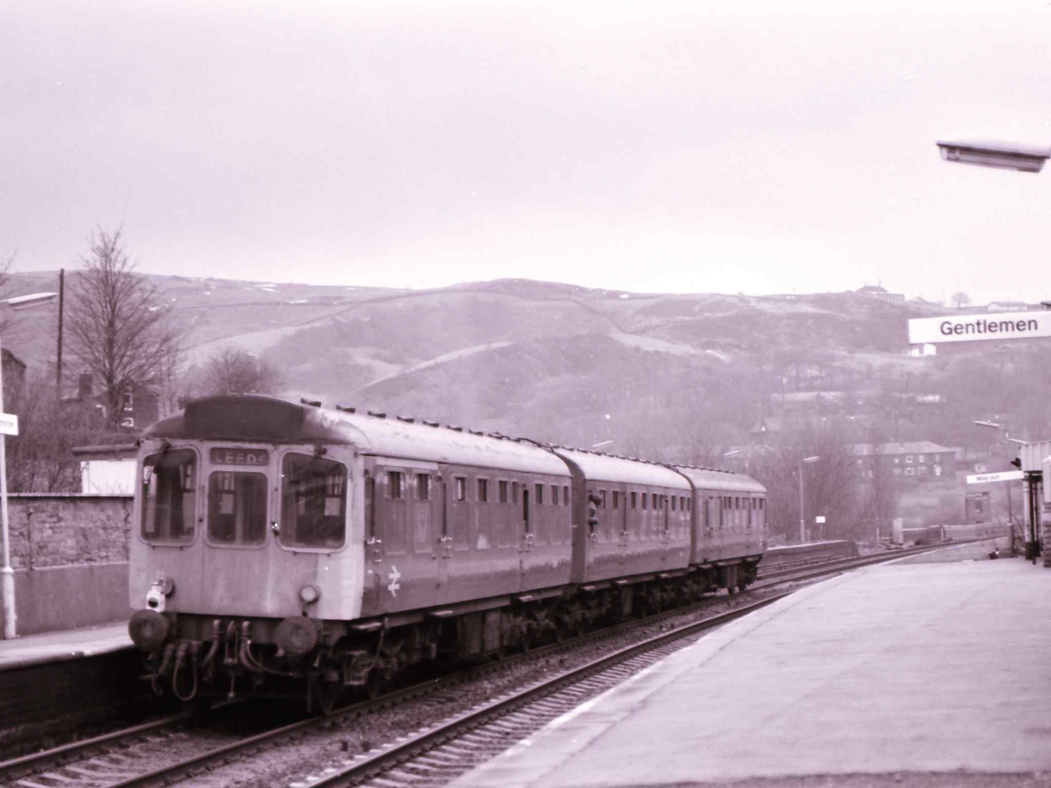 Class 110 Calder Valley unit departs from Todmorden towards Leeds on the down Manchester. The unit is in BR corporate blue and still has three cards, although the headcoe box has been painted over.