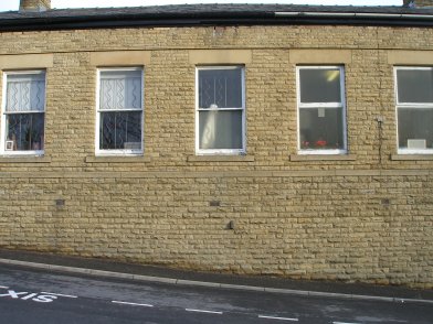 Todmorden Railway Station: second section of southern wall of main station building  westwards from entrance on 19 April 2013