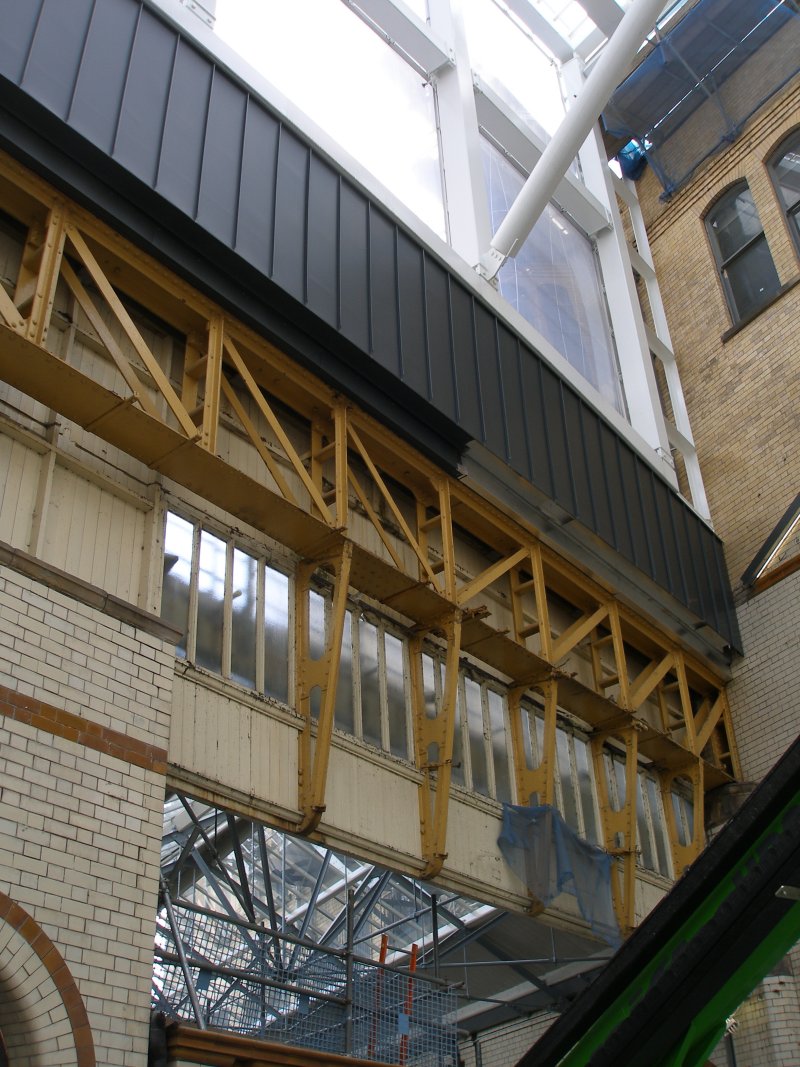 Manchester Victoria Railway Station 11 April 2015 on the occasion of a guided tour organised by the Lancashire & Yorkshire Railway Society: photo showing last remaining girder of the suburban station, and showing how the new roof is supported above it.