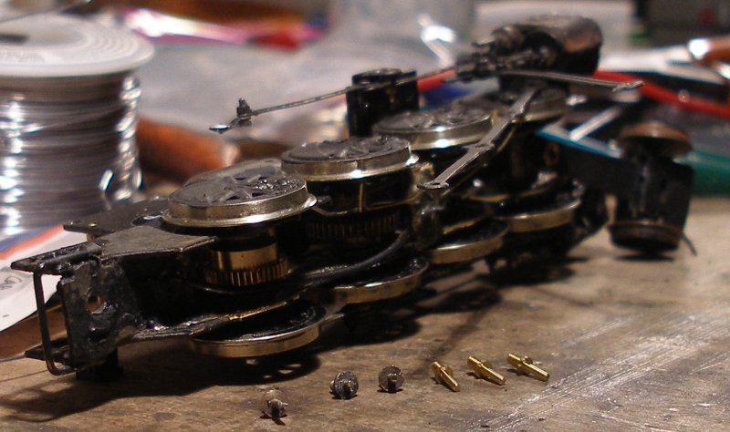 Fitting Romford crank pins -1: The new crank pins are laid out on the bench alongside the old set. As previously noted, the originals are 'blind' in that they don't have the cuts in the face to take the Romford screw driver. This would have meant that they would have been screwed in using a pair of pliers, which is probably why they have now worked loose.