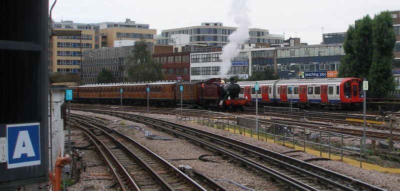 Small Prairie L.150 stands at the rear of the Watford 90 train in the turn-back siding whilst an S8 stock train heads past towards Harrow-on-the-Hill station on 13 September 2015.