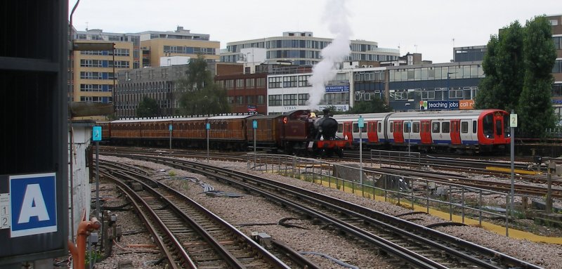 Small Prairie L.150 stands at the rear of the Watford 90 train in the turn-back siding whilst an S8 stock train heads past towards Harrow-on-the-Hill station on 13 September 2015.