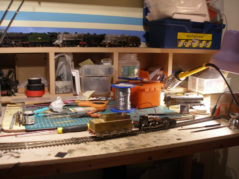 Model railway workbench showing DJH WD receiving a new Portsecap motor and in the process of being reassembled.