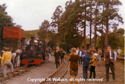 ex-PQR 'Linda' standing at Tan-y-Bwlch water tank having worked a train up from Portmadoc Sunday 31 July 1966. A small group of passengers are gathering around Driver Allan Garraway as he examines the motion on the fireman's side of the loco.